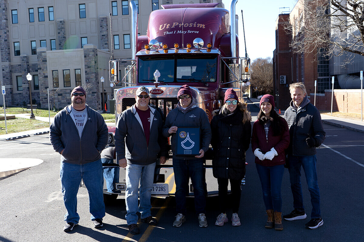 The Sharing the Road team (from left to right: Mark Golusky, Scott Tidwell, Eileen Herbers, Susan Soccolich, and Rich Hanowski) posing with an award after their semi-truck was given the rank of cadet sergeant first class during a ceremony conducted with the Corps of Cadets.